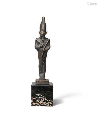 An Egyptian bronze figure of Osiris wearing the white crown