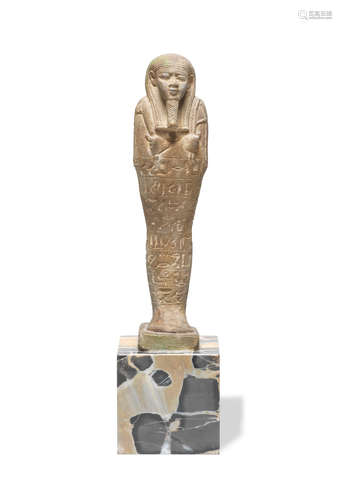 An Egyptian green glazed composition shabti for the Commander of the Army, Ankh-wah-ib-re-si-Neith