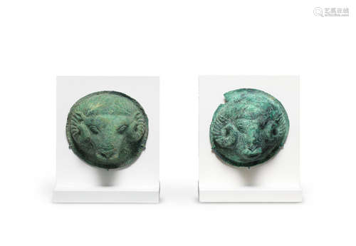 Two Etruscan bronze votive shield bosses with rams' heads