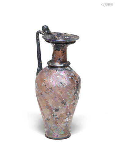 A Roman aubergine glass oinochoe