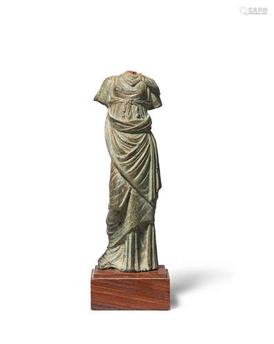 A Greek bronze statuette of a draped female figure