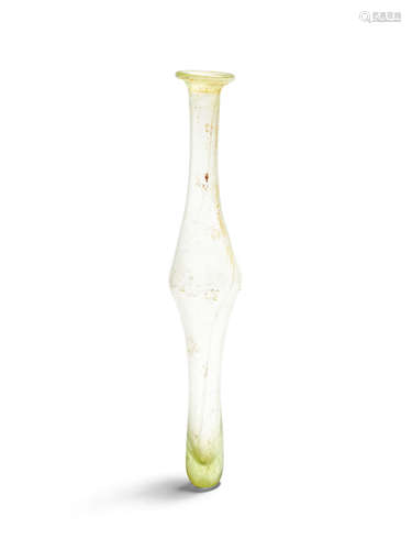 A Roman pale green glass tall unguentarium