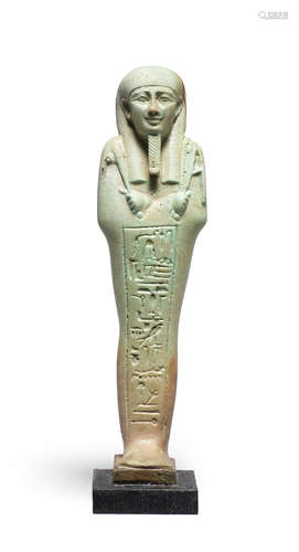 An Egyptian green glazed composition shabti for Tjai-Hor-pa-ta