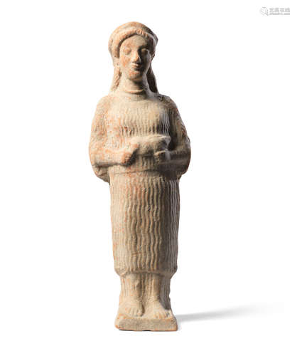 A Greek terracotta female votary holding a piglet