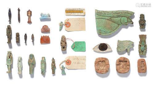 A group of Egyptian amulets, an eye inlay, a small shabti and three terracotta amulet moulds