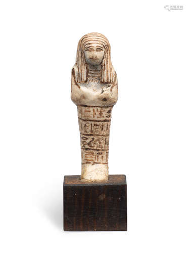 An Egyptian white glazed composition shabti for Mery-Ptah