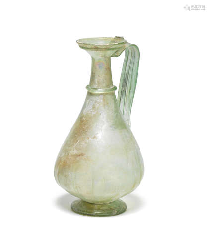 A large Roman light green glass jug