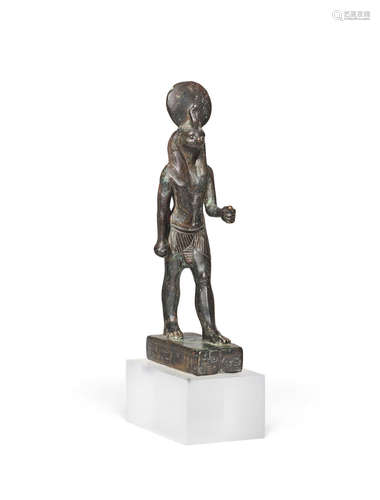 An Egyptian bronze figure of a falcon-headed god