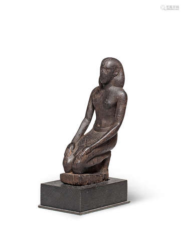 An Egyptian wood kneeling figure