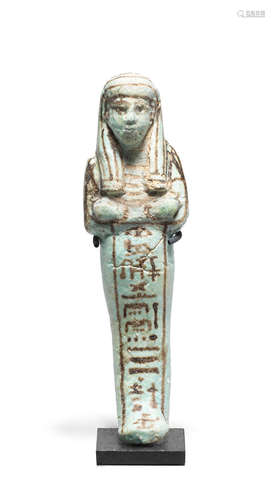 An Egyptian turquoise glazed composition shabti for the Royal Scribe Nefer-Hotep