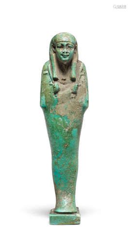 An Egyptian green glazed composition shabti