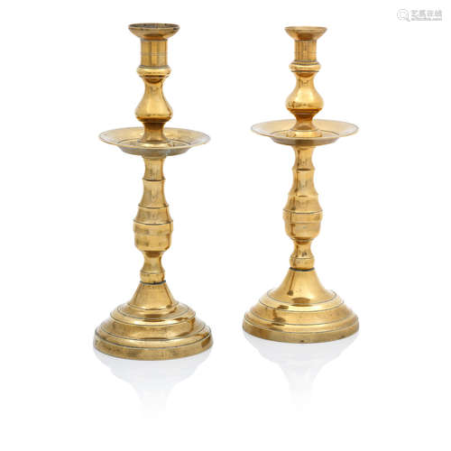 A near pair of late 19th/early 20th century brass candlesticks