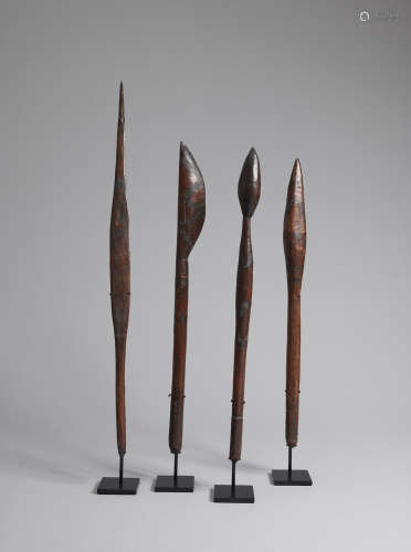 A spearthrower and three clubs, New South Wales heights: 88.0cm (34 5/8in)., 73.5cm (28 15/16in)., 71.0cm (27 15/16in)., 70.0cm (27 9/16in). Maker Unknown