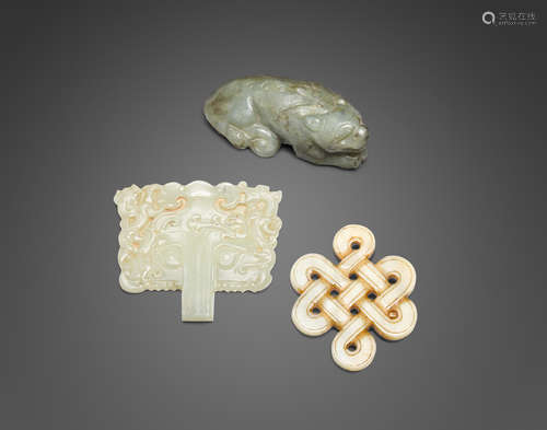 a group of three jade carvings