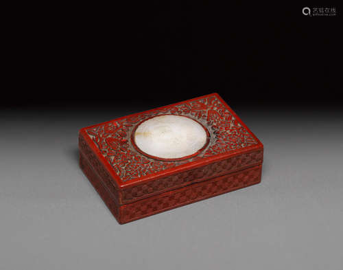 A cinnabar lacquer rectangular box mounted with a jade plaque