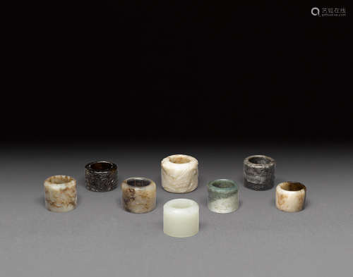 a group of eight nephrite and hardstone rings