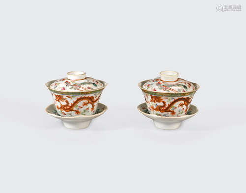 A pair of famille rose enameled lidded tea bowls and stands  Qianlong marks, Republic period