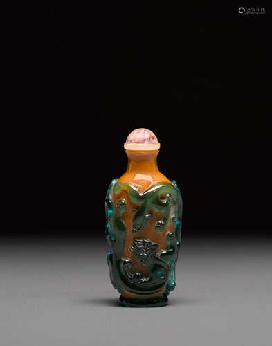 Probably Imperial, attributed to the Beijing Palace Workshops, late 18th century A green overlay cafe au lait glass 'chilong' snuff bottle