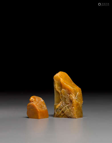 A group of two yellow soapstone seals