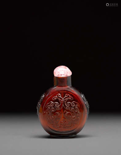 Probably Imperial, attributed to the Beijing Palace Workshops, 18th century An expertly carved amber-red glass snuff bottle