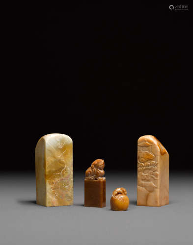 A group of four soapstone seals and carvings