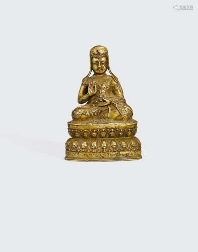 Tibet, 16th century A copper-inlaid gilt copper alloy figure of a lama