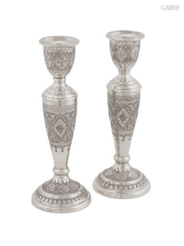 marked 84, early 20th Century  A pair of Persian silver candlesticks