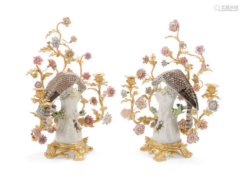 20th century A Pair of Louis XV Style Gilt Bronze Mounted Floral Encrusted Porcelain Figural Candelabra