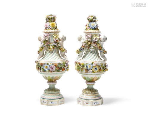 20th century A pair of German porcelain floral encrusted figural covered vases