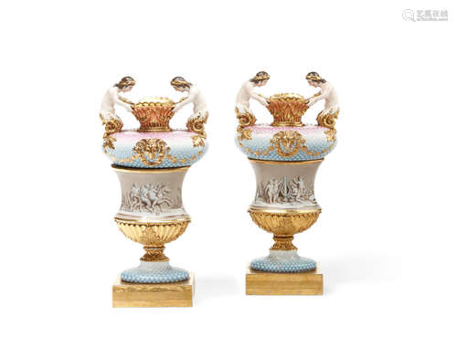 A pair of French polychromed porcelain vases with figural handles