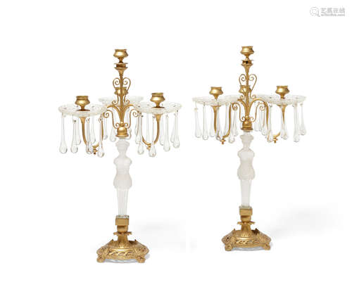 A pair of Empire style gilt metal mounted molded frosted glass figural four light candelabra