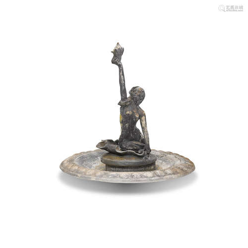 A Patinated Bronze Mermaid fountain on a cast stone circular basin