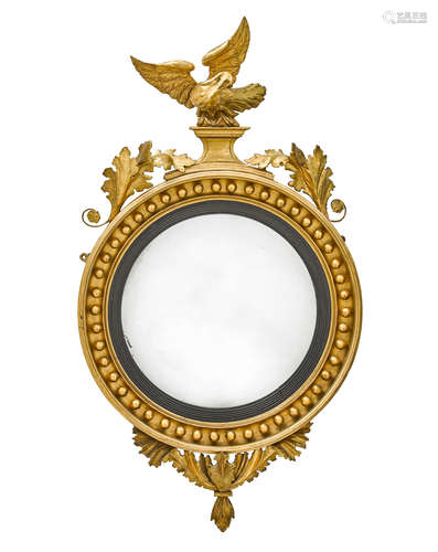 19th century A Regency Part Ebonized and Giltwood Convex Mirror