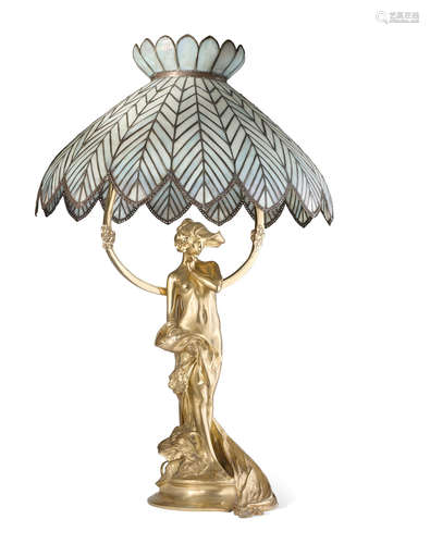 Circa 1900For Louchet, signed in the maquette 'CH Korschann', and with foundry seal 'PARIS LOUCHET CISELEUR'.height 32 1/2in (82.5cm); diameter 21in (53cm)  An Art Nouveau gilt bronze and leaded glass figural lamp Charles Korschann (1872-1943) and Paul François Louchet (1854-1936)