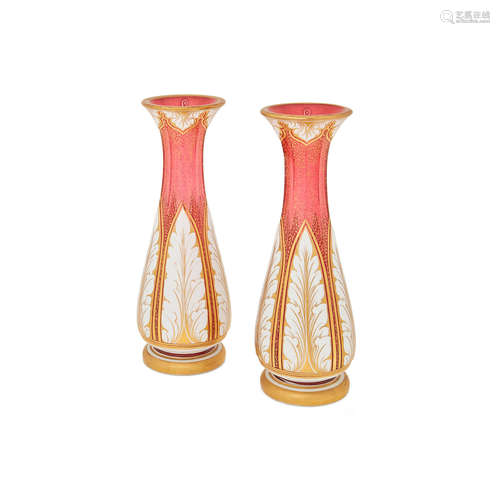 Late 19th/early 20th century A Pair of Bohemian gilt decorated white cased ruby glass vases