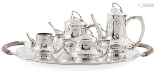 Early 20th centuryComprising a tea pot, water pot, sugar bowl with cover, creamer and tray, stamped WMF and with various hallmarks.length of tray 23½in (60cm); height of tea pot 9in (23cm)  A Wurttembergische Mettalwarenfabrik (WMF) Silver Plated Metal and Mahogany Five piece Tea Set