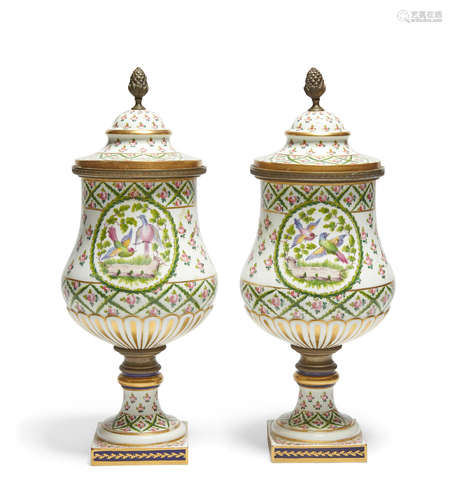 A pair of Sèvres style porcelain covered urns