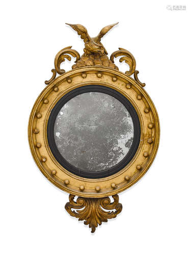 First quarter 19th century A Regency Parcel Ebonized Giltwood Convex Mirror