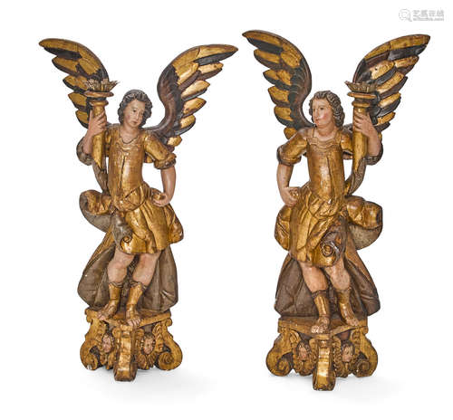 A pair of Baroque polychromed and giltwood angel candlesticks