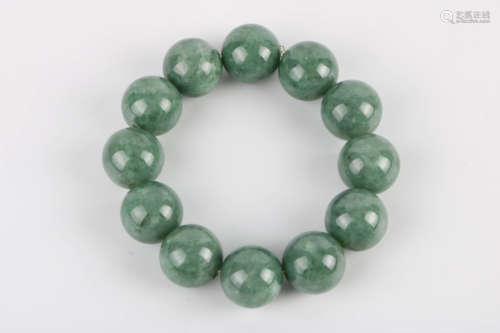 A Chinese Carved Jadeite Bracelet