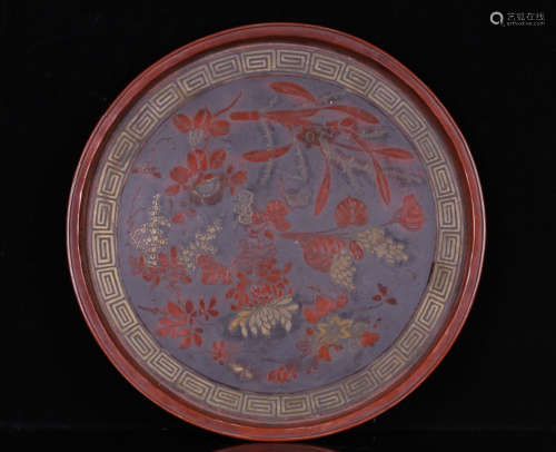 A BRONZE PLATE WITH FLOWERS PATTERN