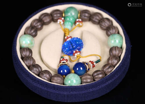 A CHENXIANG WOOD BRACELET WITH JADEITE AND GLASS