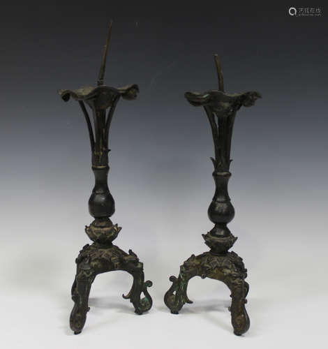 A pair of Chinese brown patinated bronze pricket candlesticks, probably Ming dynasty, each with