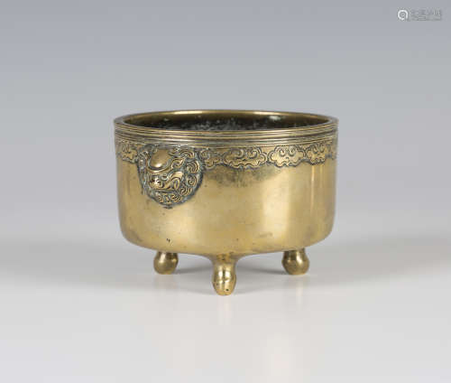 A Chinese polished bronze censer, mark of Xuande but Qing dynasty, of cylindrical form with reeded