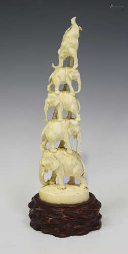 A Japanese ivory okimono figure group, Meiji period, carved and pierced with five balancing