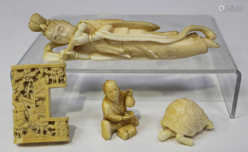 A small group of Oriental ivory carvings, late 19th century, comprising a Japanese recumbent