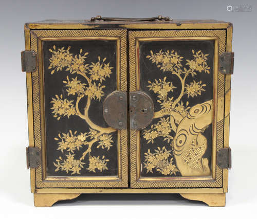 A Japanese lacquer kodansu, Meiji period, of rectangular form with copper handle, hinges and mounts,