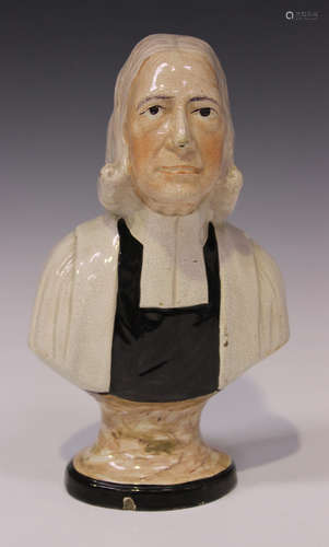 A Staffordshire pottery bust of John Wesley, circa 1830, modelled in ministerial dress on a tapering