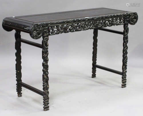 A Chinese hardwood altar table, early 20th century, the rectangular panelled top with curved ends,