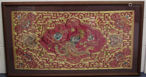 A Chinese burgundy silk embroidered rectangular panel, 20th century, worked in coloured and gilt